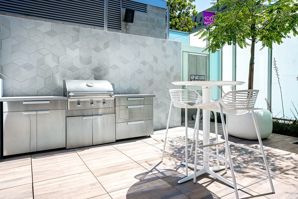 Hollywood Apartments for Rent - Sunset Vine Tower - Grilling Station with Stainless-Steel BBQ Grill, High Chairs, and Potted Trees