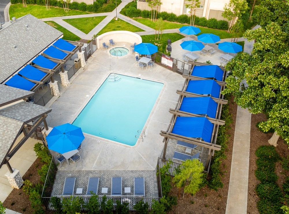 an aerial view of a swimming pool with blue umbrellas at Sunstone Place, California, 92505