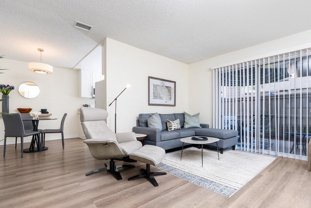 a living room with a couch and a chair and a dining room table at Sunstone Place, Riverside, CA, 92505