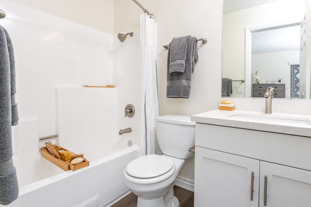 a bathroom with a toilet and a tub and a sink at Sunstone Place, Riverside, California