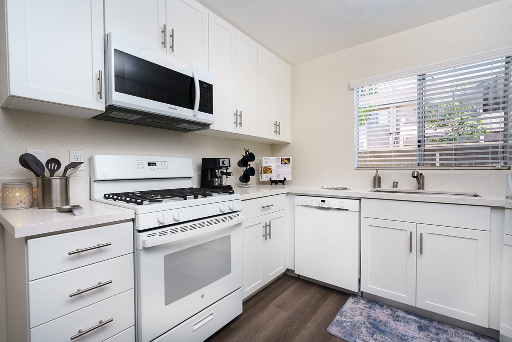 a kitchen with white cabinets and white appliances at Sunstone Place, Riverside, 92505