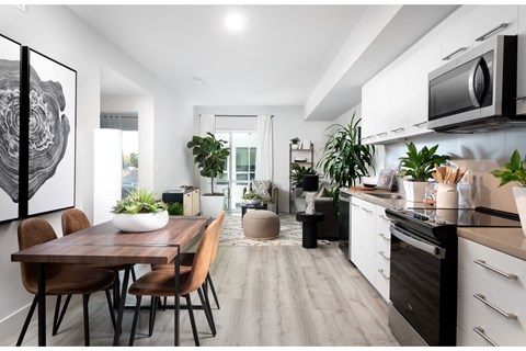 an open kitchen and dining room with a table and chairs