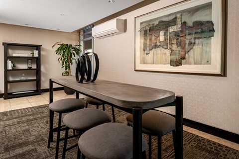 A dining area with a table and chairs.
