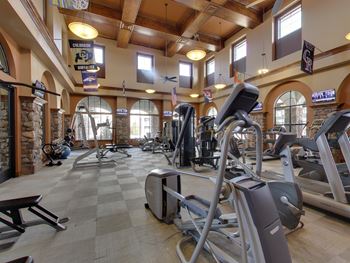 A gym with a variety of exercise equipment.