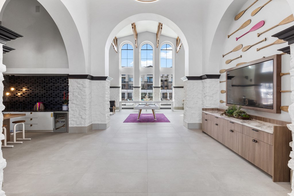 the lobby of a church with an arched ceiling and a tv and a table at Terracina, Colorado