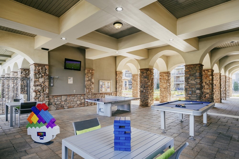 Outdoor area with a pool table and a TV mounted on the wall. at Terracina, Broomfield, CO