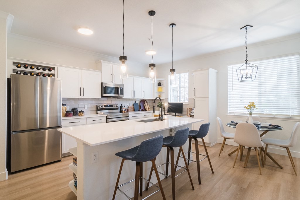 a kitchen with a large island and a dining table with chairs at Terracina, Colorado