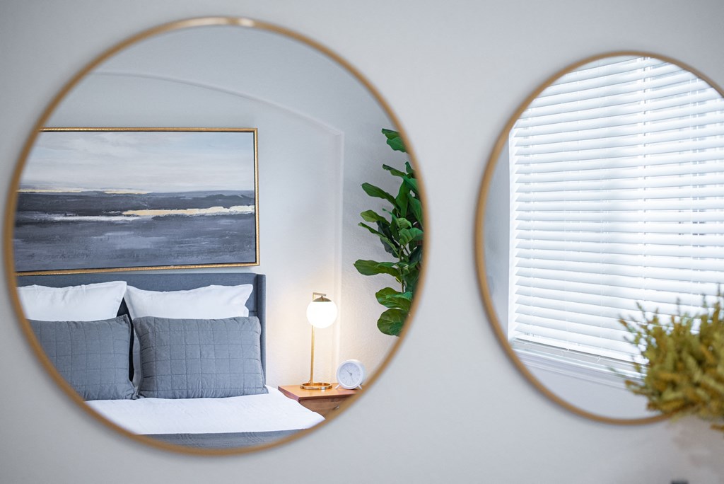 a room with a bed and two mirrors on the wall at Terracina, Broomfield