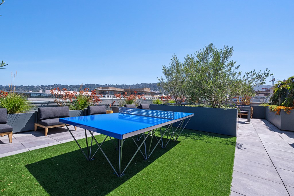 Three-BR Apartments In Berkeley, CA - The Addison - Rooftop Patio With A Ping Pong Table, City Views, And Outdoor Furniture