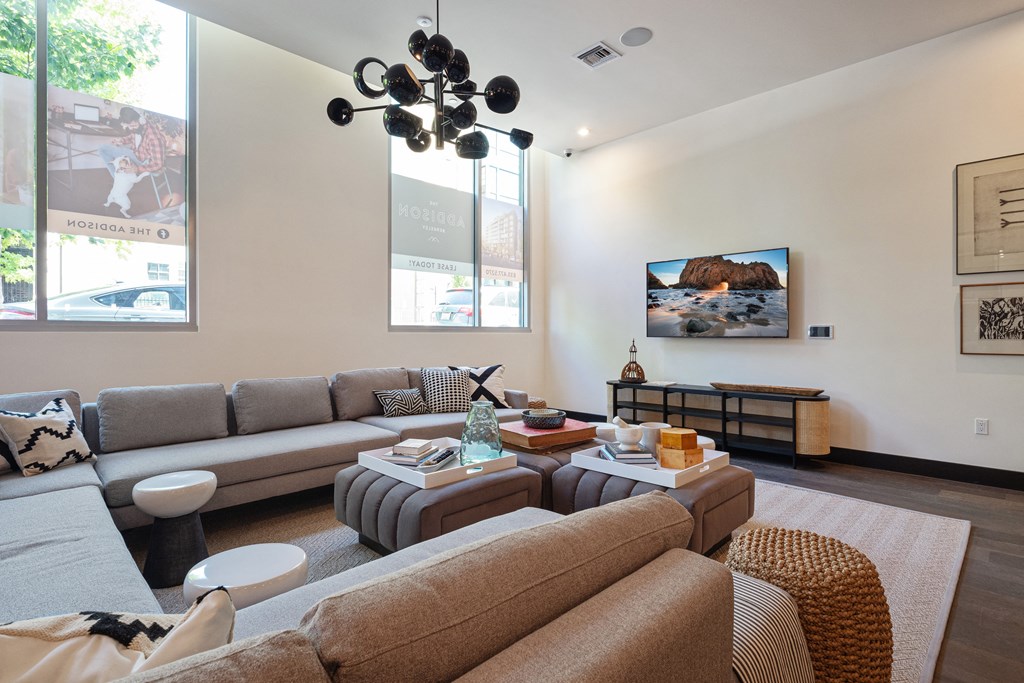 a living room with couches and a coffee table and a television