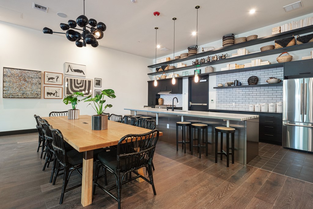 Studio Apartments in Downtown Berkeley, CA - The Addison - Private Dining Area With A Catering Kitchen, Stainless Steel Refrigerator, Chairs, Table, Stove, And Island