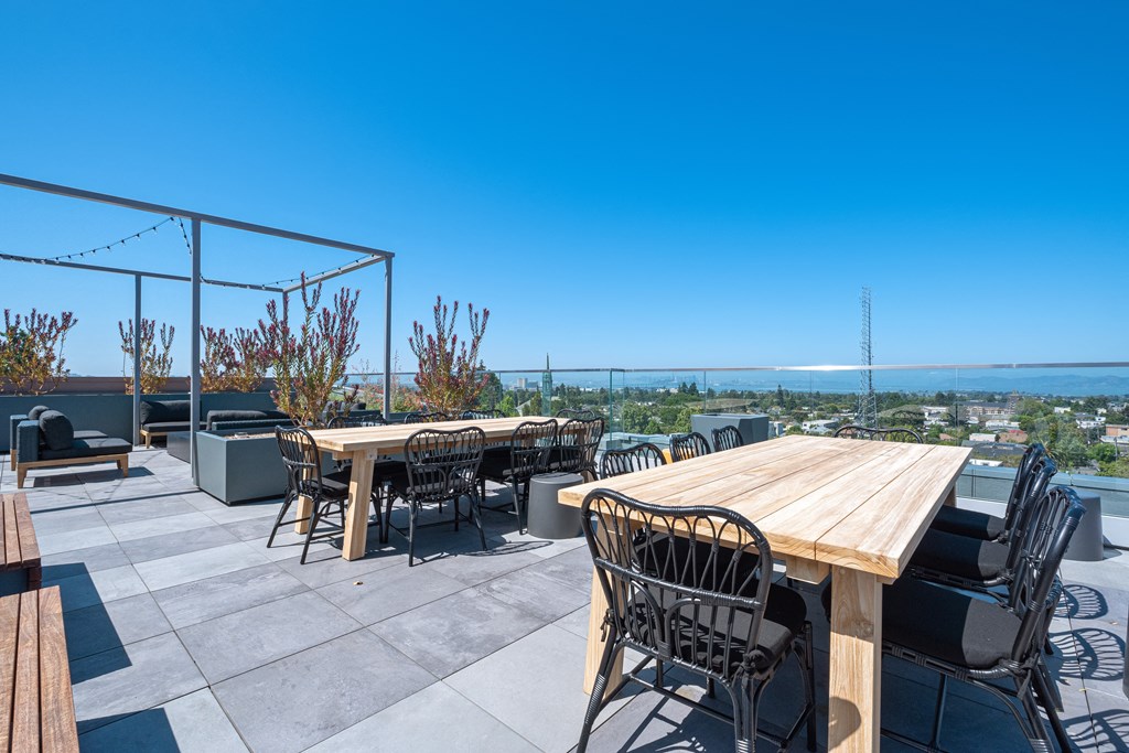 the roof terrace of a restaurant with tables and chairs