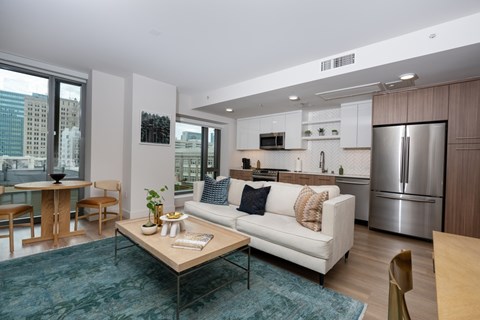 A modern living room with a white couch and a coffee table.