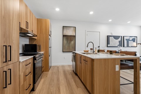 A modern kitchen with wooden cabinets and appliances.