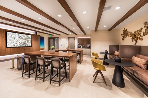 A modern dining room with a long table and chairs.