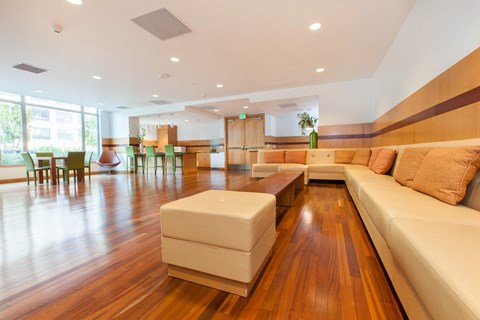 A modern living room with a white sofa and wooden floors.