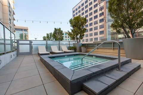 Rooftop hot tub with lounge chairs at The Grand Apartments, Oakland, CA 94612