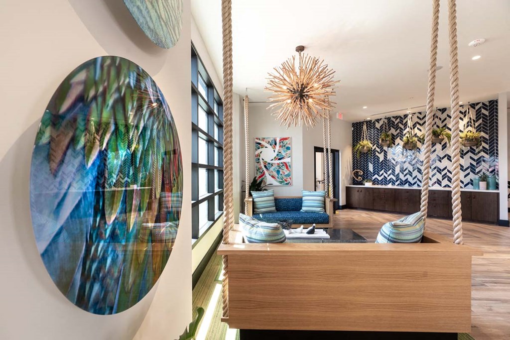 a living room with a large round mirror on the wall