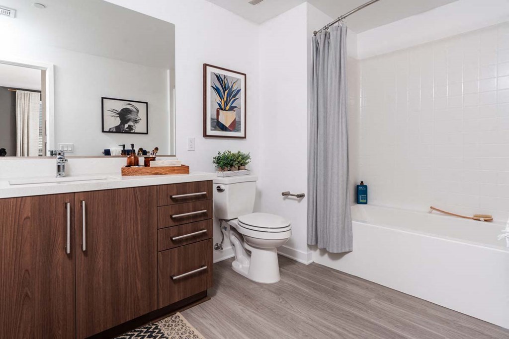 a bathroom with a toilet and a shower and a sink