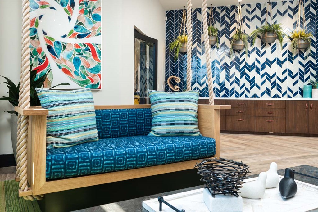 a living room with a swing chair and pillows