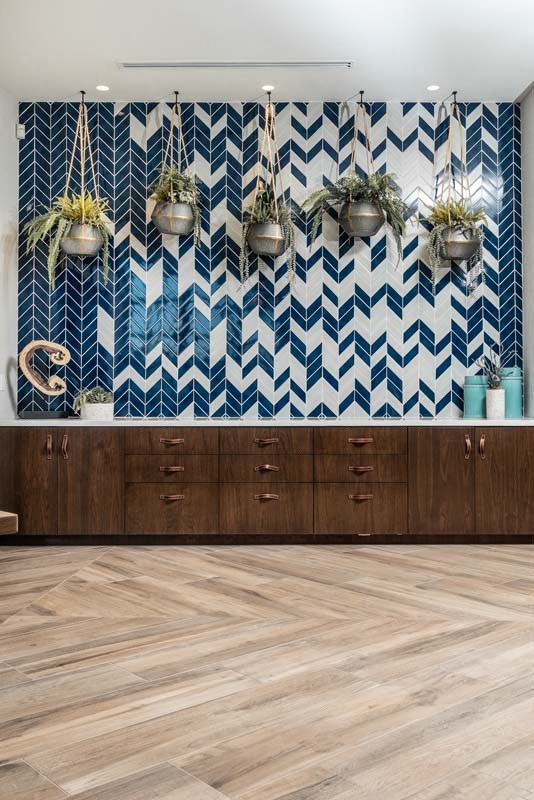 a kitchen with blue and white chevron wallpaper and wood floors