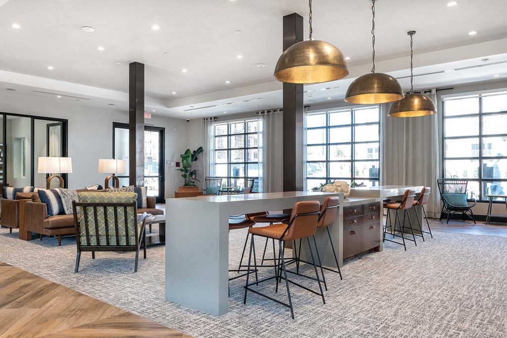 a large living room with a bar and a dining room