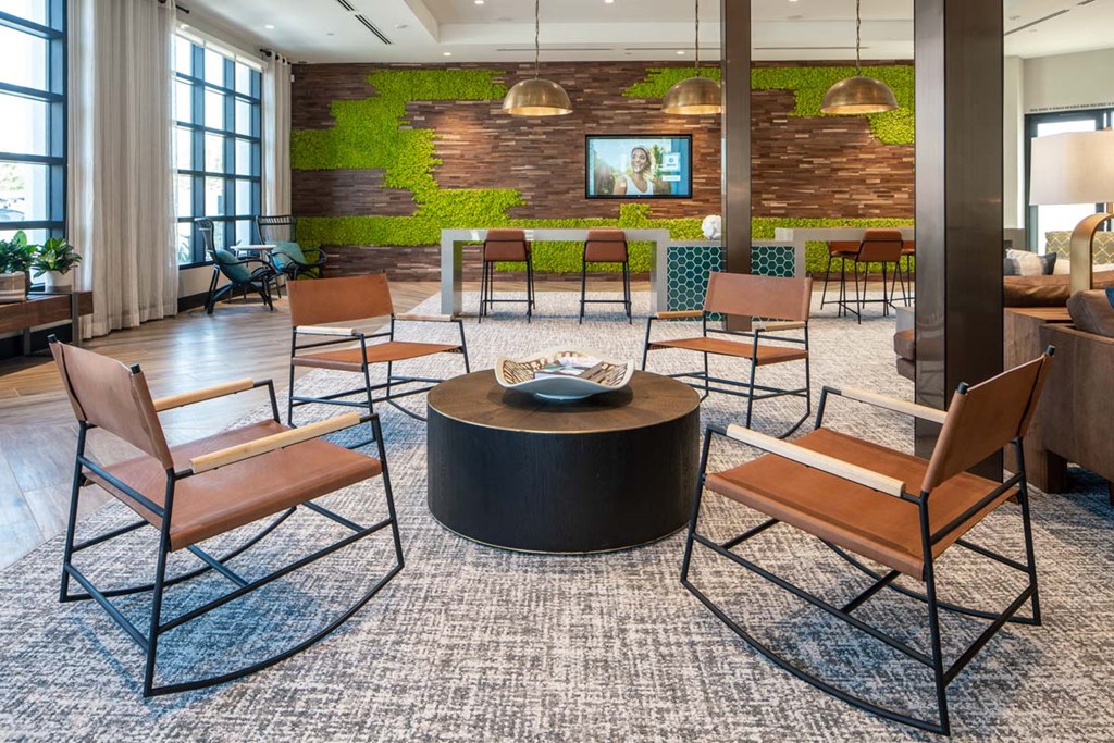 a lounge area with a table and chairs in a lobby