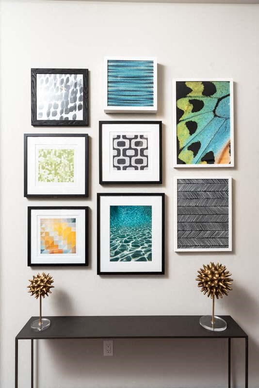 a gallery wall of framed pictures on a white wall
