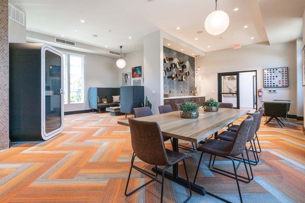 a large dining room with a wooden table and chairs