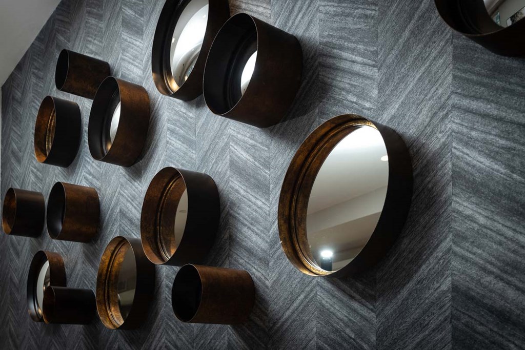 a group of mirrors hanging on a wall