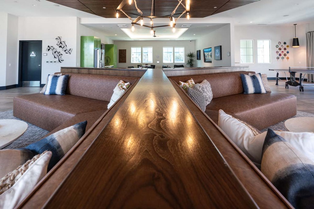 a long table in the center of a living room with couches