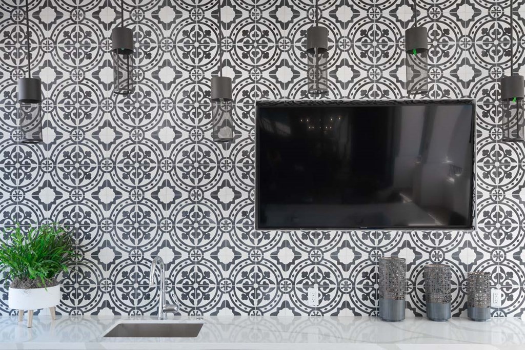 a black and white wallpaper with a tv on a wall