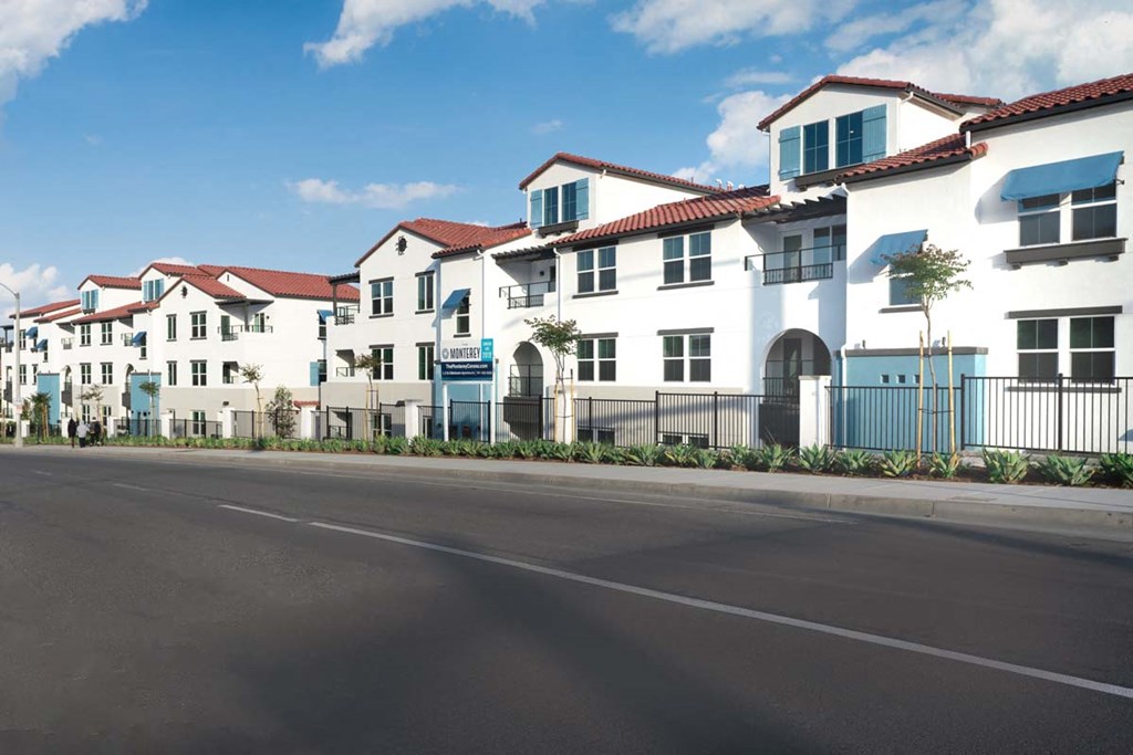 a row of white houses on the side of a street