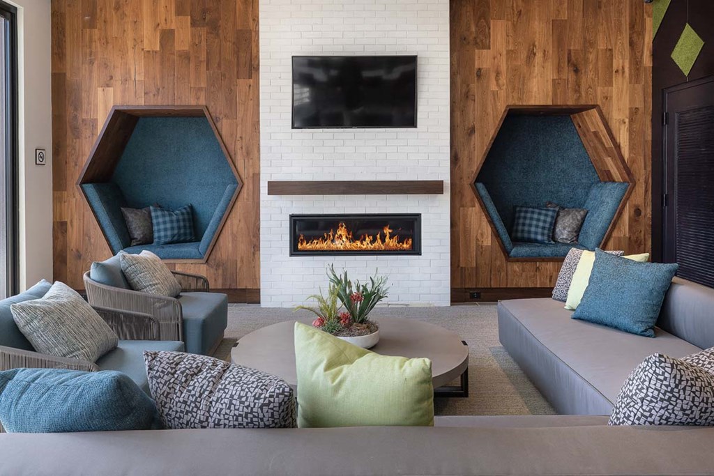 a living room with couches and chairs and a fireplace
