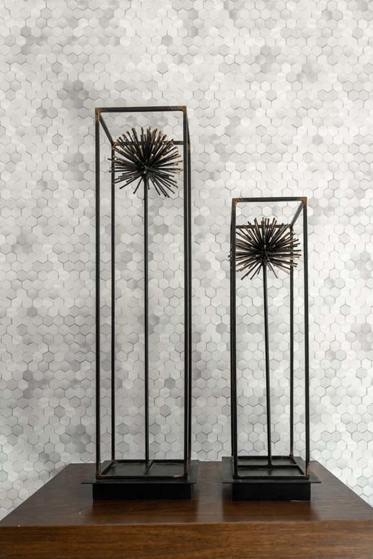 a pair of metal torches on display on a table