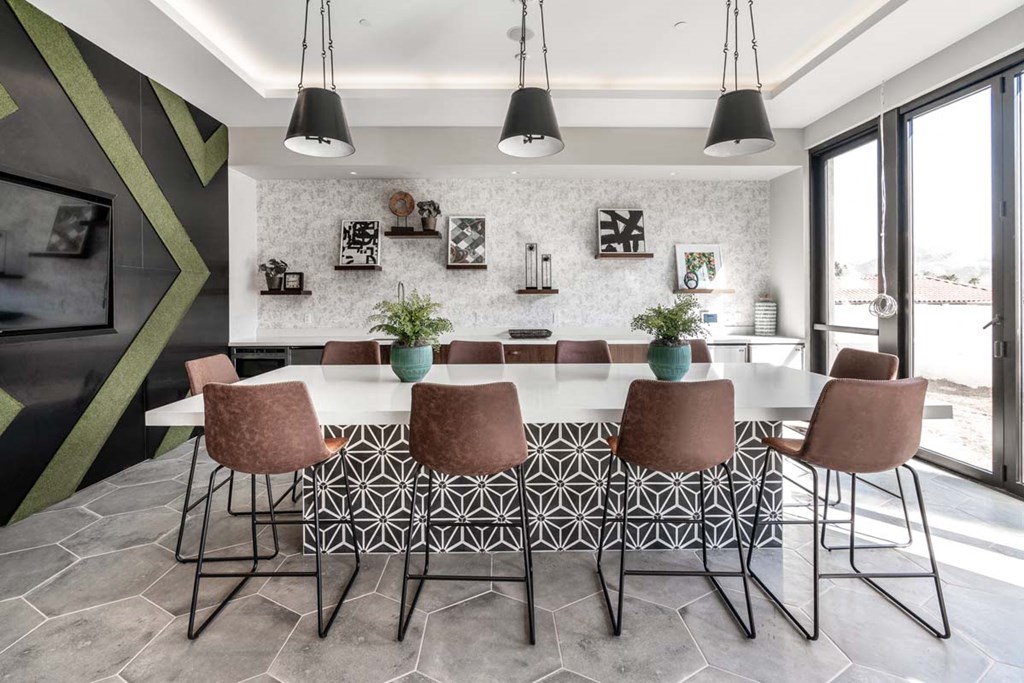 a dining room with a large table and chairs