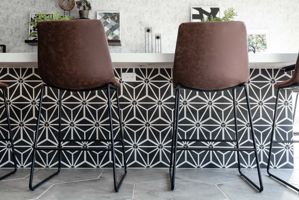 a pair of brown chairs sitting next to a bathroom sink