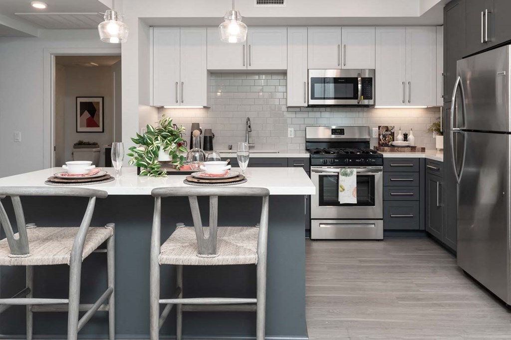 a kitchen with a center island and stainless steel appliances