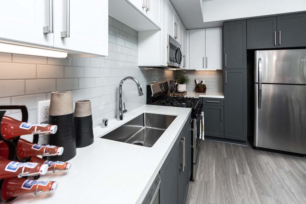 a kitchen with a sink and a refrigerator