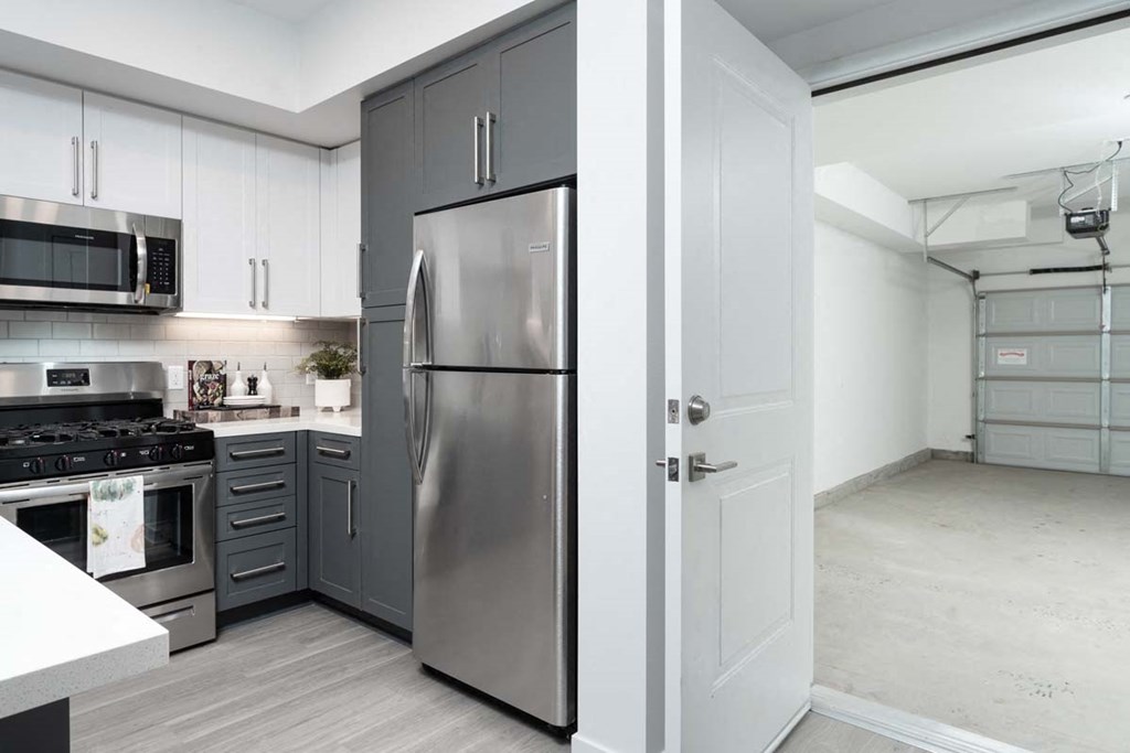 a kitchen with stainless steel appliances and white cabinets