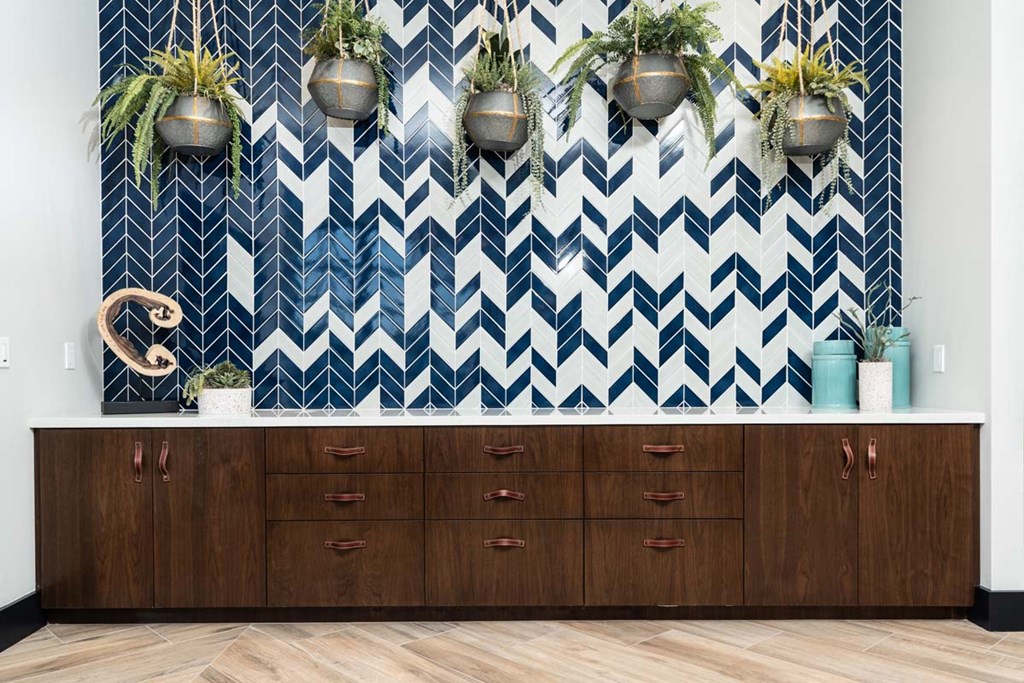 a large wooden dresser with a blue and white wallpaper