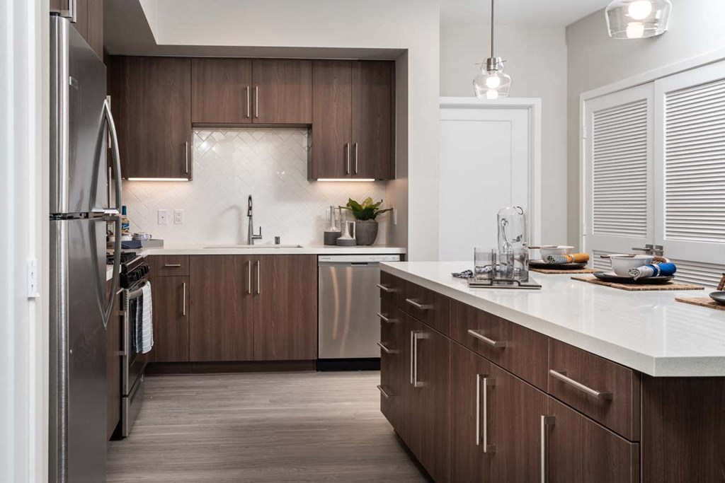 a large kitchen with wooden cabinets and stainless steel appliances