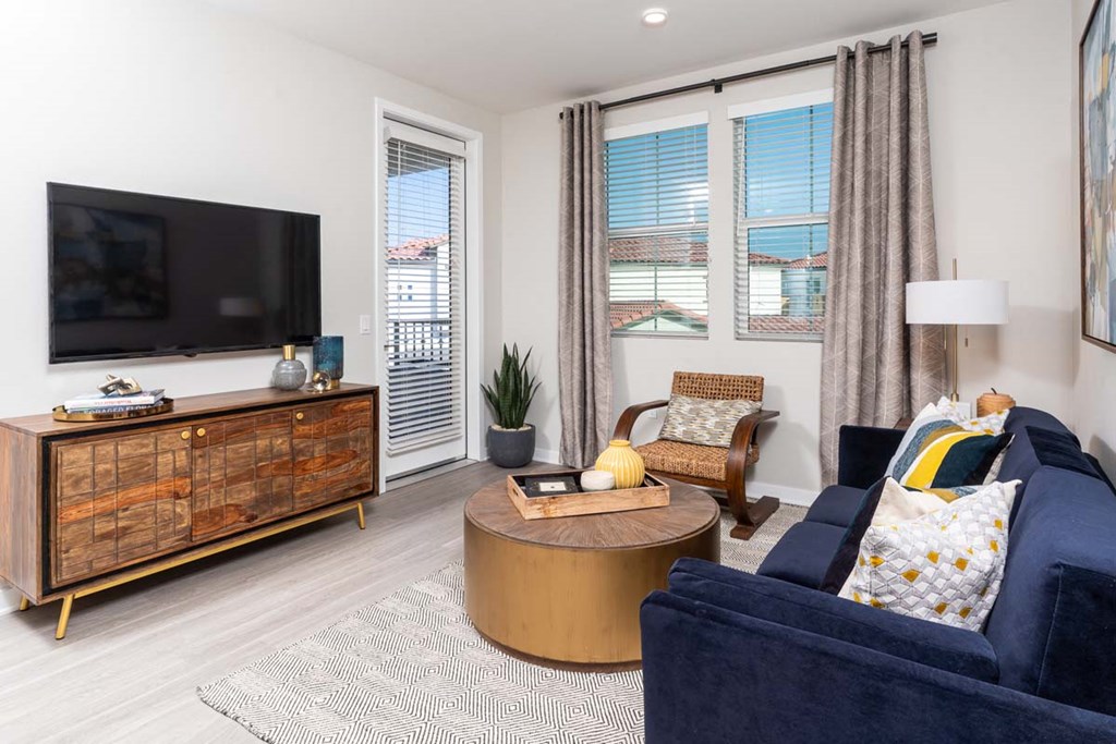 Pet-Friendly Apartments in Corona, CA - The Monterey Corona - Living Room with Hardwood-Style Floors, Large Windows, and Access to the Patio/Balcony