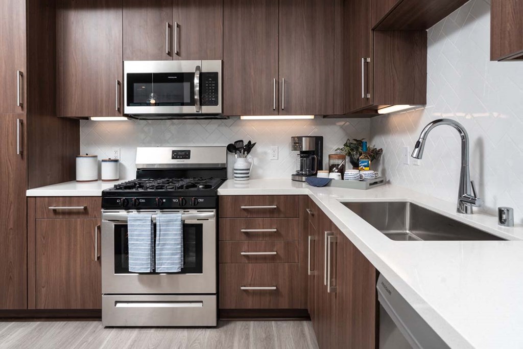 a kitchen with stainless steel appliances and wooden cabinets