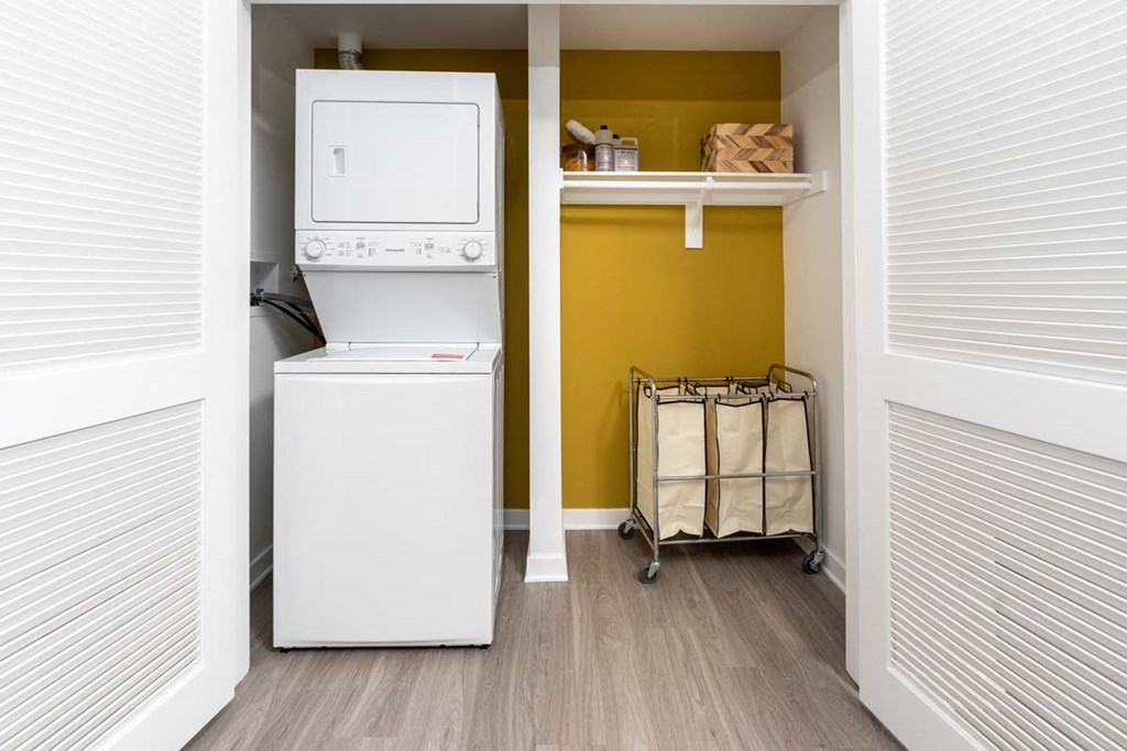 a laundry room with a washing machine and a washer and dryer