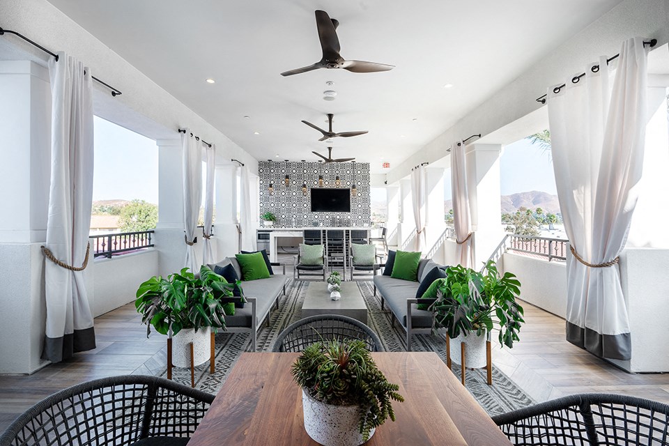 a living room with a table and chairs and a couch and a television