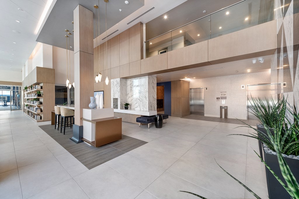 a large lobby with a reception desk and a library