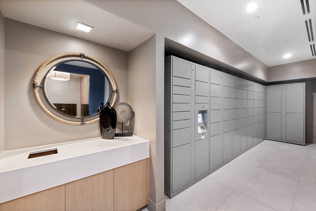 a long white closet with a mirror and drawers