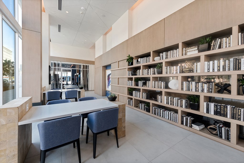 a library with tables and chairs and a large book shelf