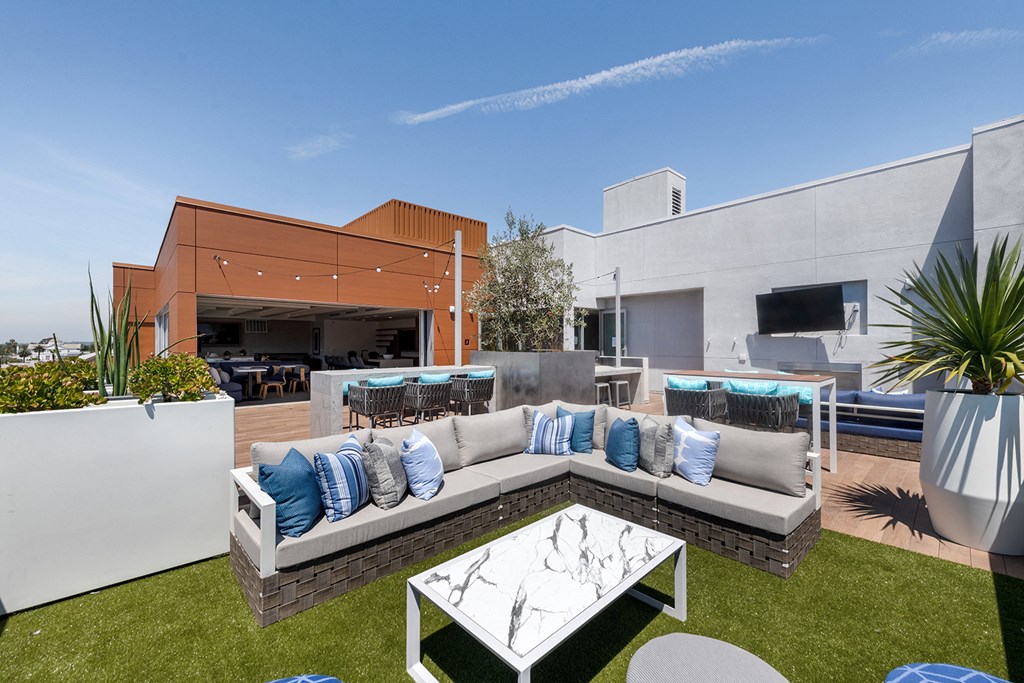 a living area with a couch and a table on a lawn